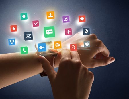 Naked female hand with smartwatch and  application labels around and dark background