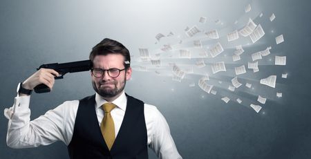 Handsome businessman shoots his head with gun and documents coming out from his head