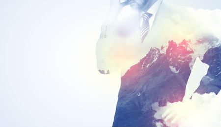 Businessman standing and thinking with snowy mountain graphic