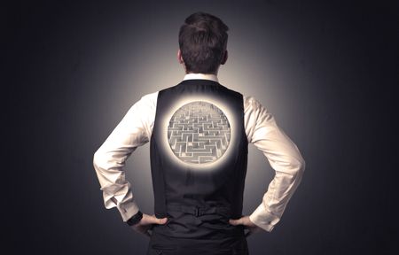 Businessman standing and thinking with maze graphic on his back