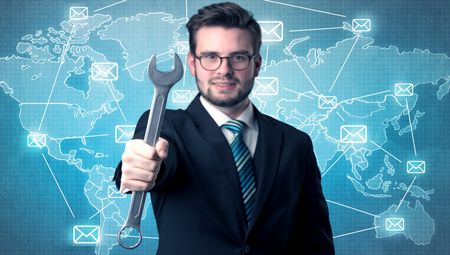 Businessman holding tool with global map graphic on the background