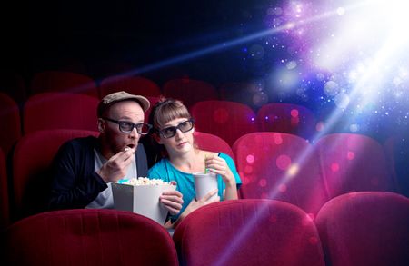 Romantic couple cuddling and watching the miraculous part of the film