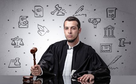 Handsome judge with court symbols around