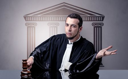 Young judge in front of a courthouse symbol making decision