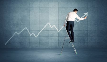 A man standing on a ladder and drawing a chart on blue wall background with exponential progressing curve, line