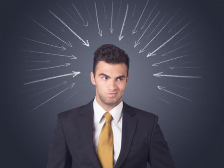 Young businessman with arrows pointing to his head