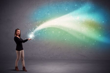 Caucasian woman holding blue, white, green coloured stria of light