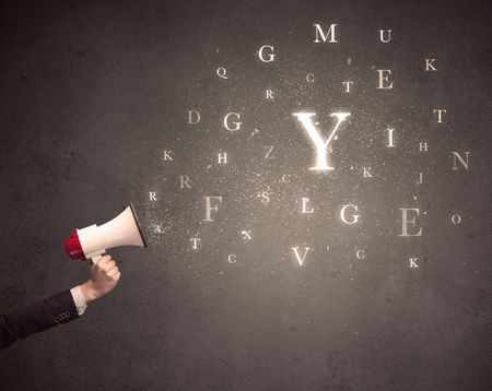 Caucasian business arm holding megaphone with letter cloud