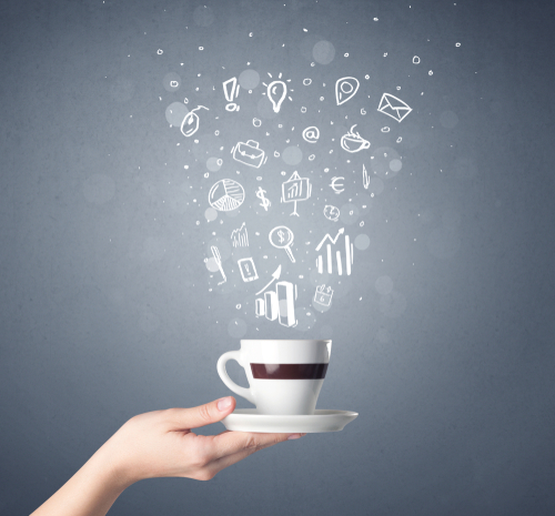 Young female hand holding coffee cup with business related drawings above it 