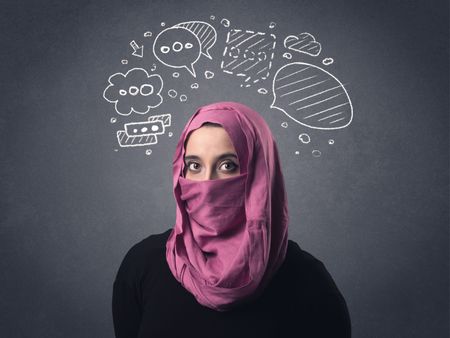 Young muslim woman wearing niqab with drawn speech bubbles above her head 