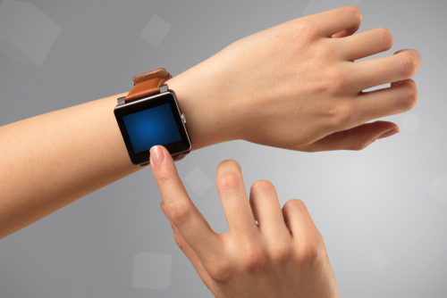 Female hand wearing smartwatch with free space on the screen