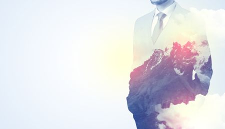 Businessman standing and thinking with snowy mountain graphic
