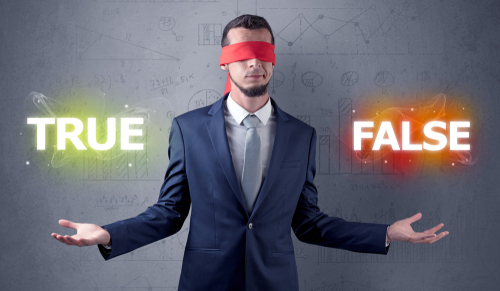 Businessman with red ribbon on his eye deciding true or false