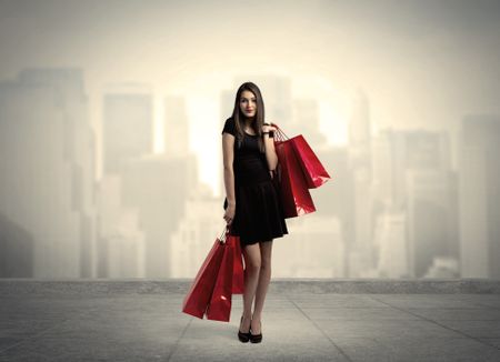 A stylish female standing with red shopping bags on platform and city view landscape backround concept