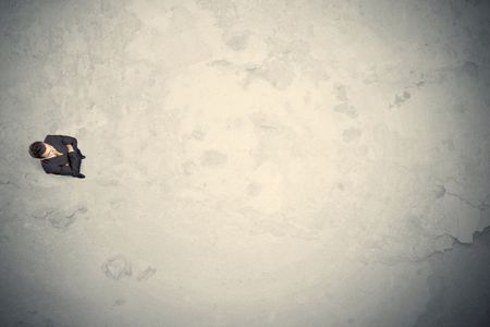 Business man from top standing with copy space desert background