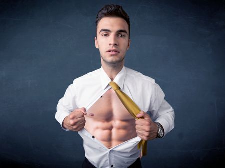 Businessman tearing off his shirt and showing mucular body concept on background