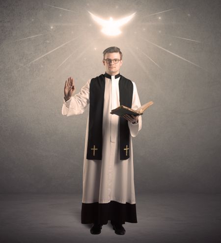 A holy priest reading a prayer from the holy bible with illustrated glowing angel above his head concept.