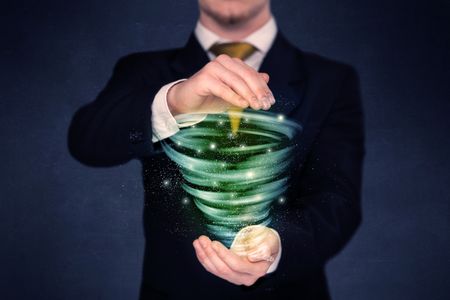 Bright green tornado in the hands of a businessman 