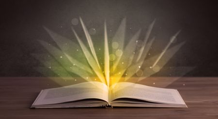 Yellow lights spreading from an open book 