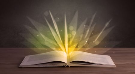 Yellow lights spreading from an open book