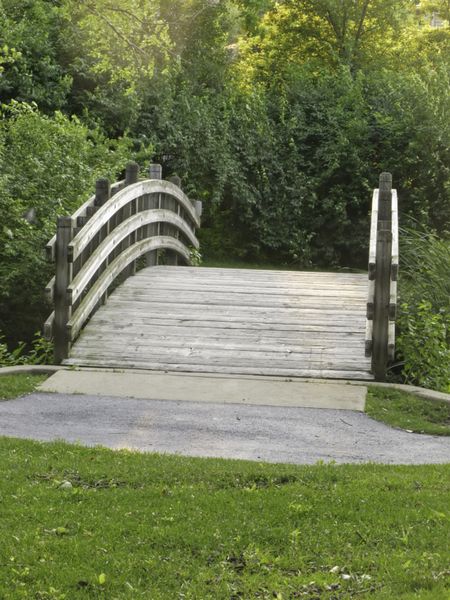 Mystery of the other side: Arched wooden bridge for pedestrians and bicyclists