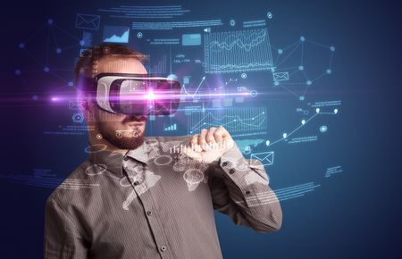Amazed businessman with virtual reality business plan in front of him 