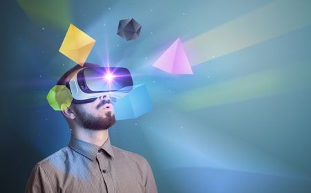 Amazed businessman with virtual reality colorful geometric shapes in front of him