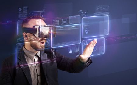 Amazed businessman with virtual reality charts and data in front of him