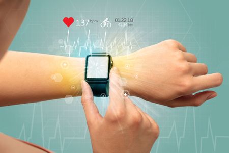 Hand with smartwatch and cycling concept nearby.