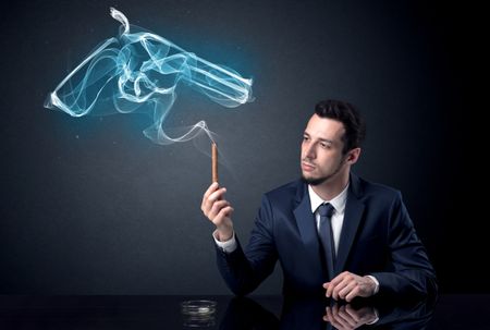 Businessman resting and smoking in a dark room.