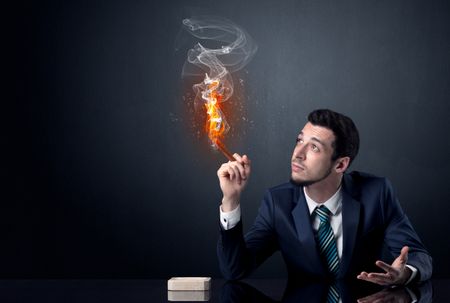 Businessman smoking with inferno effect.