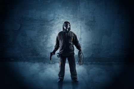 Big peril men in front of a crumbly wall with dangerous stuffs in his hand