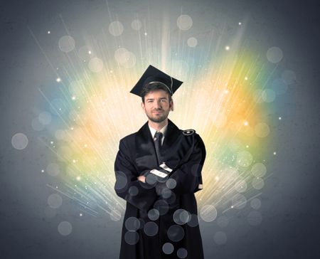 Happy graduate with colorful bokeg lights in the background grunge wall