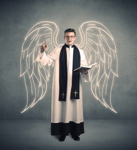 A young male priest with drawn large angel wings standing with the holy bible in his hands concept.