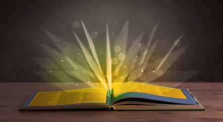 Yellow lights spreading from an open book