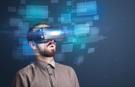 Amazed businessman with virtual reality data and blue squares in front of him 