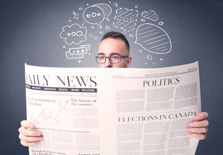 Puzzled young businessman reading daily newspaper with speech bubbles above his head