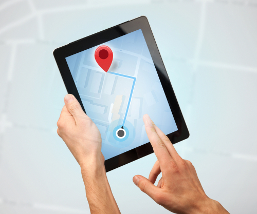 Female fingers touching tablet with map