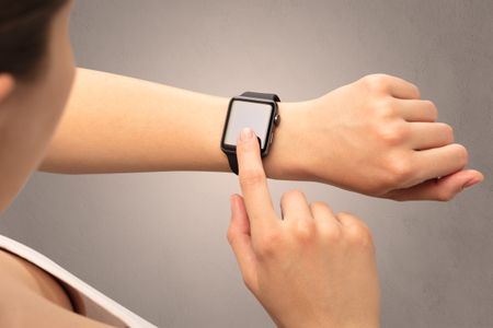 Female hand with black screen smartwatch.