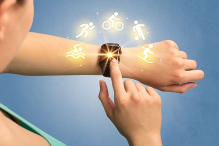 Female hand with smartwatch and sport concept.