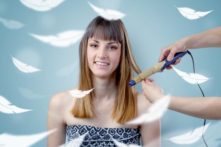 Pretty brunette woman at salon with plume around and ethereal concept