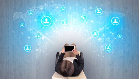 Social media concept with woman sitting on chair with tablet on her hand
