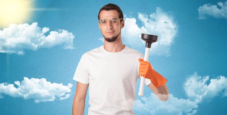 Sunny and cloudy concept with male housekeeper and orange gloves on his hand
