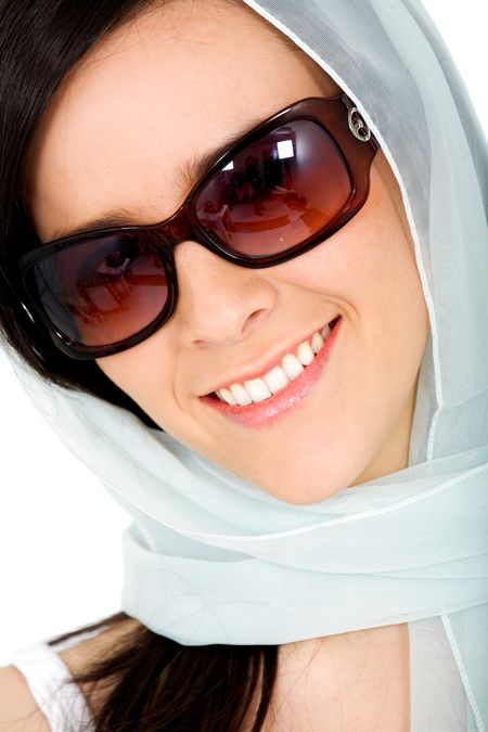 Beautiful fashion woman portrait smiling and wearing sunglasses over a white background