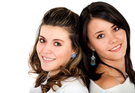 Beautiful female sisters smiling over a white background