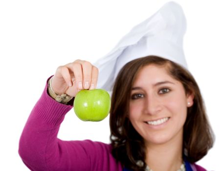Beautiful casual woman wearing a chef hat with an apple smiling and isolated over a white background
