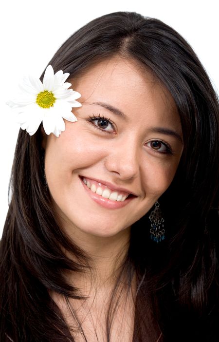 Casual woman portrait with a flower on her ear over a white background