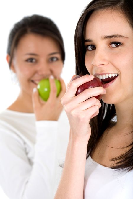 healthy girls eating apples over a white background