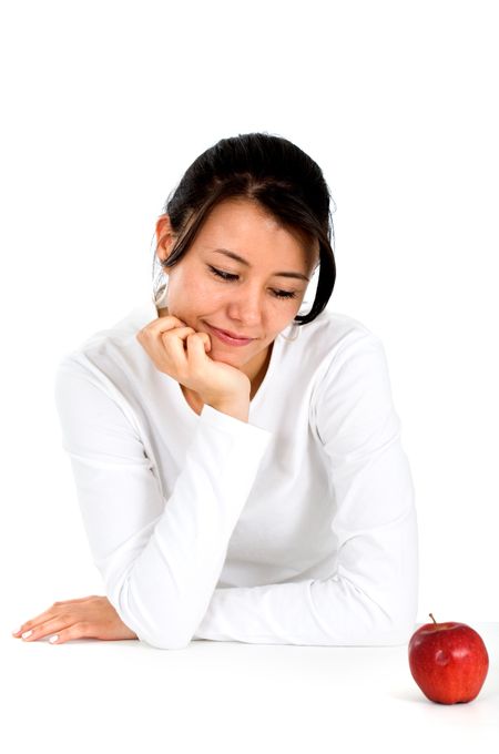 girl considering a diet looking at a red apple - isolated over a white background