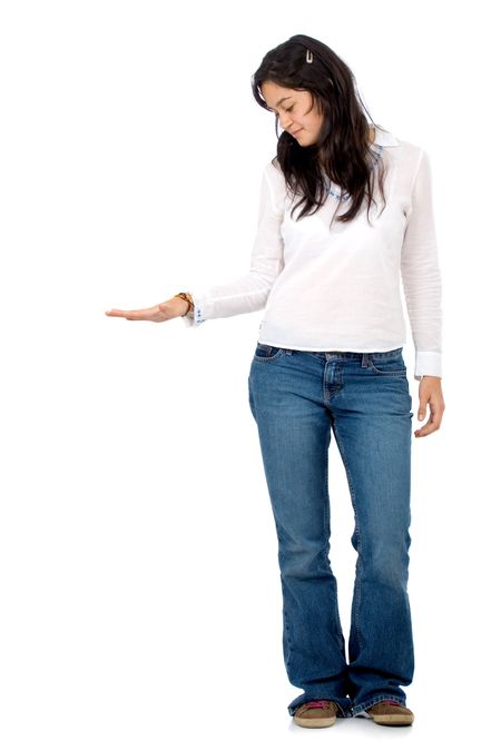 casual girl with her hand on something imaginary - isolated over a white background